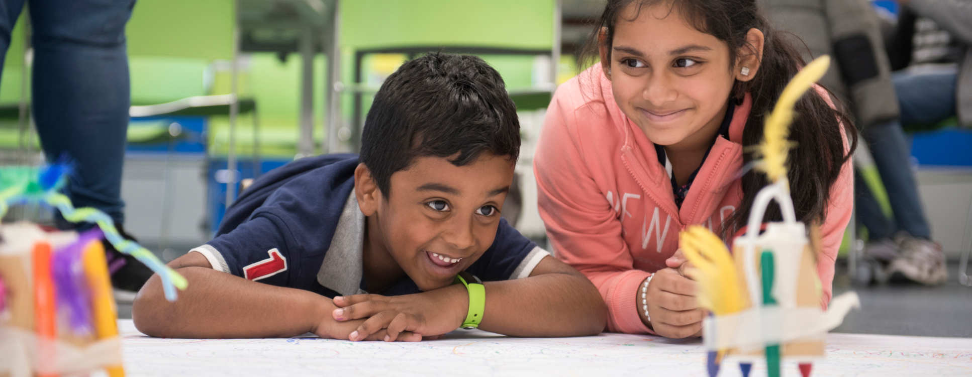 two children using scribbling robots at an event at the invention rooms 