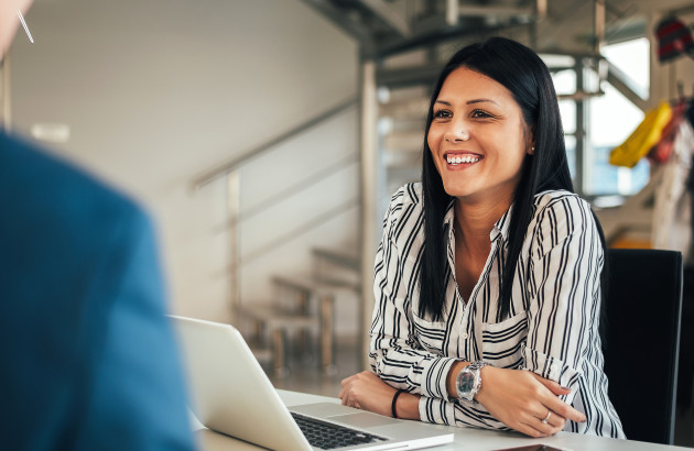 woman at desk smiling