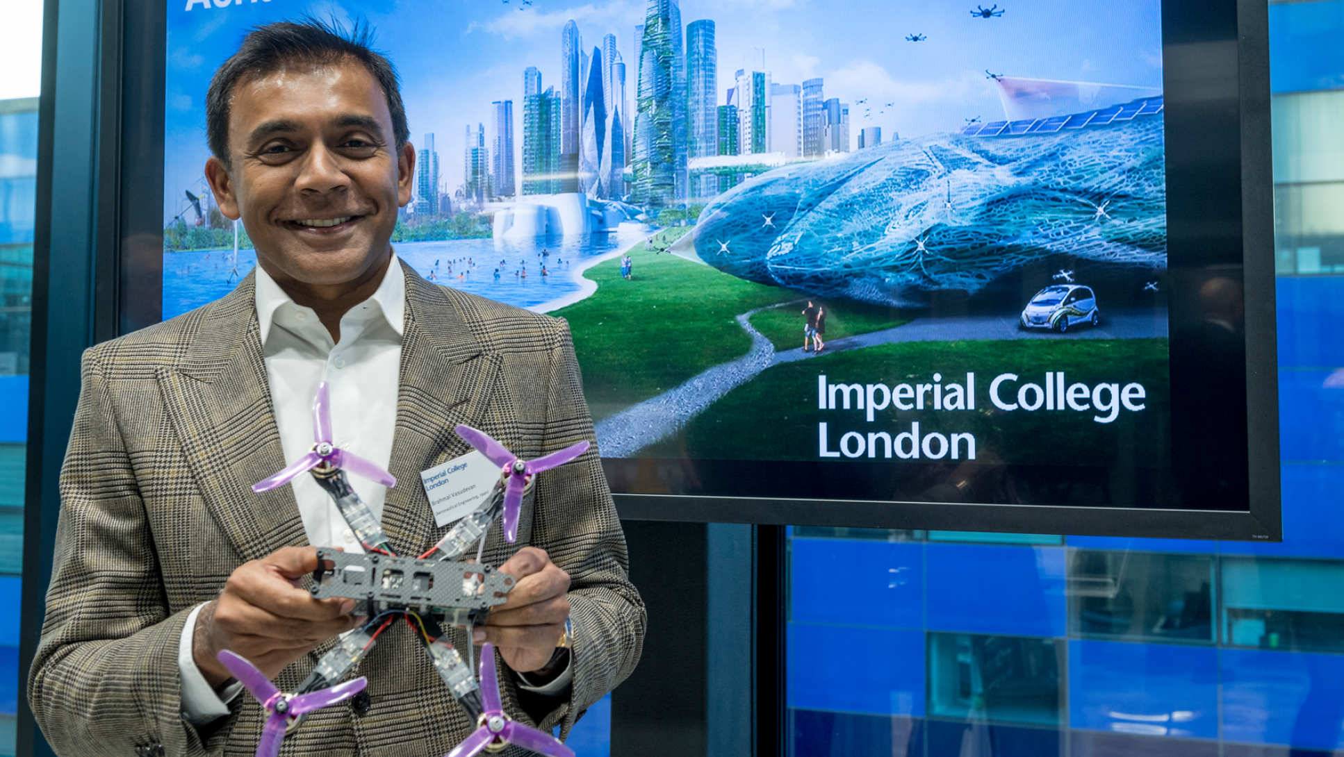 Alumnus Brahmal Vasudevan holding a drone at the opening of the Brahmal Vasudevan Multi Terrain Aerial Robotics Arena at Imperial.