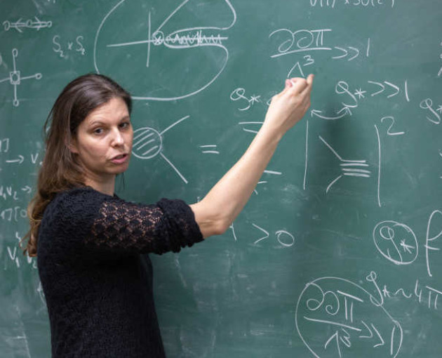 Woman writing a chalk board