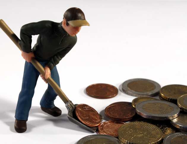 man shoveling coins