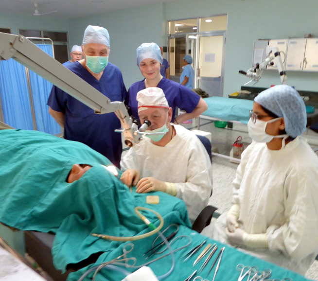 Mr Neil Weir (centre) in action at the BRINOS Ear Care Centre