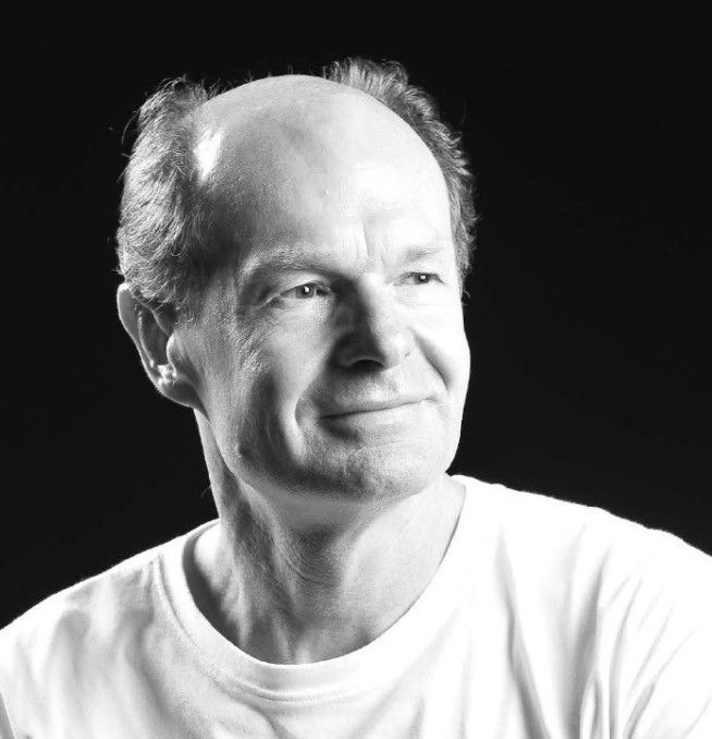 Black and white headshot of Dr Paul Van Driessche MBE (PhD Environmental Policy 2018)