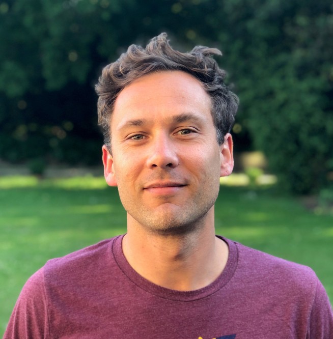 Headshot of Marcus Hill with backdrop of a park