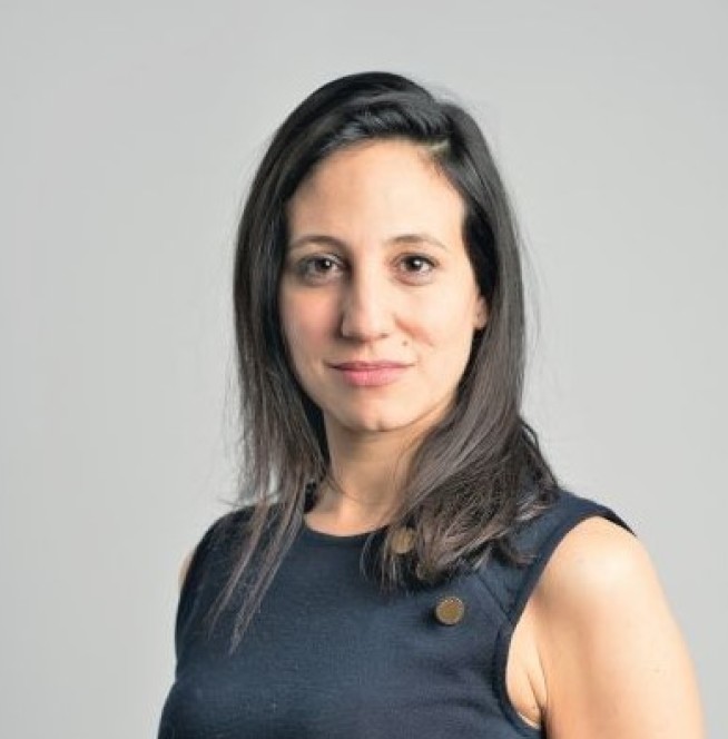 Headshot of Tiffany Howard against a grey background