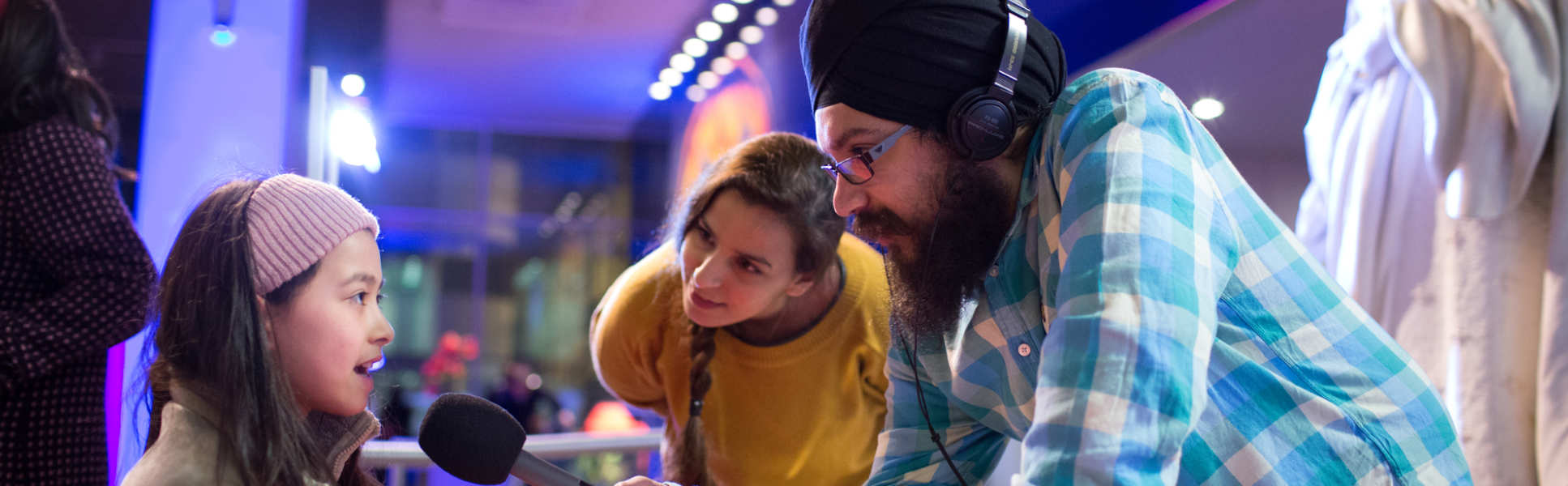 A young person speaks into a microphone