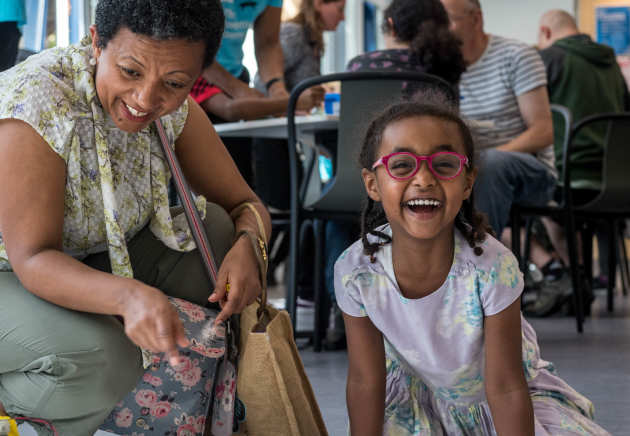 Young girl smiling at the camera when joining in an activity at White City campus