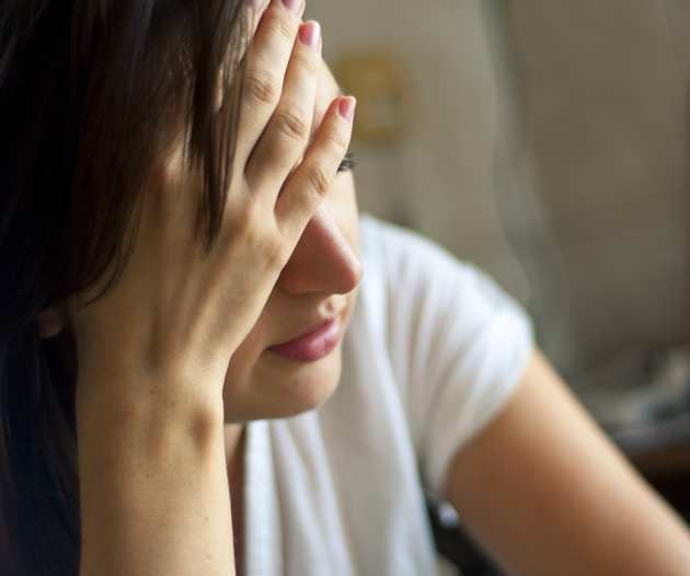 A female with her head in her hands