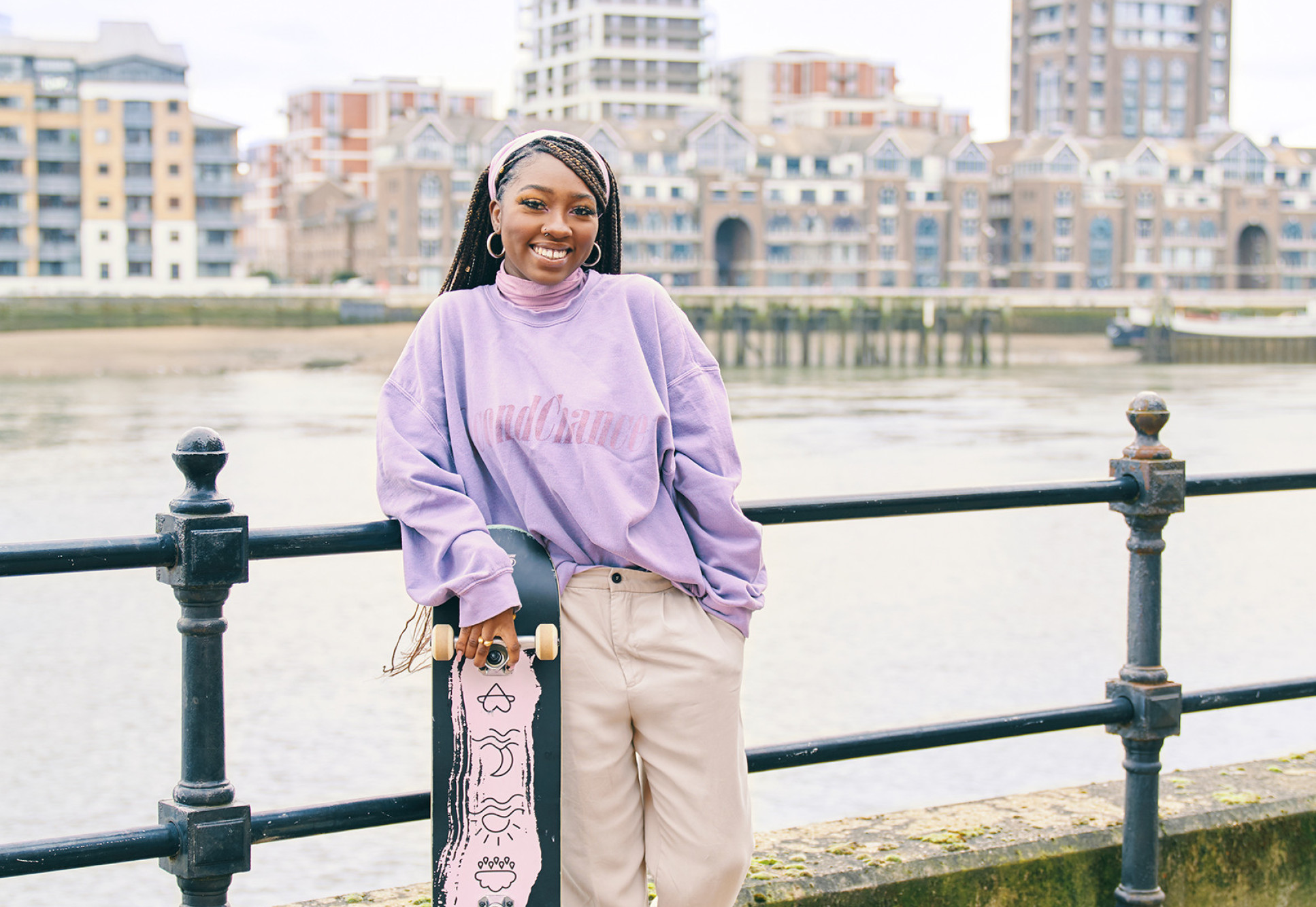 Jessica Powell by the river with her skateboard