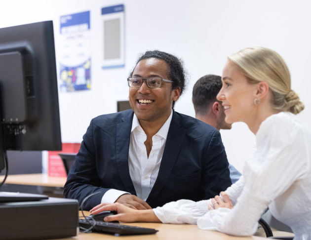 Students looking at a computer