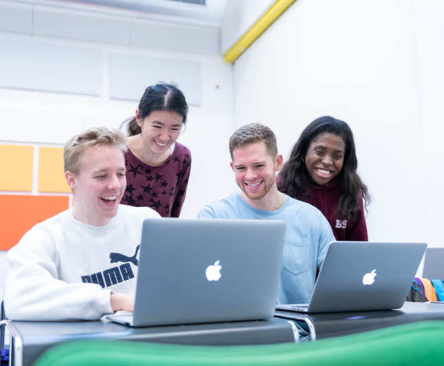 Applied Computational Science & Engineering Students looking at a laptop