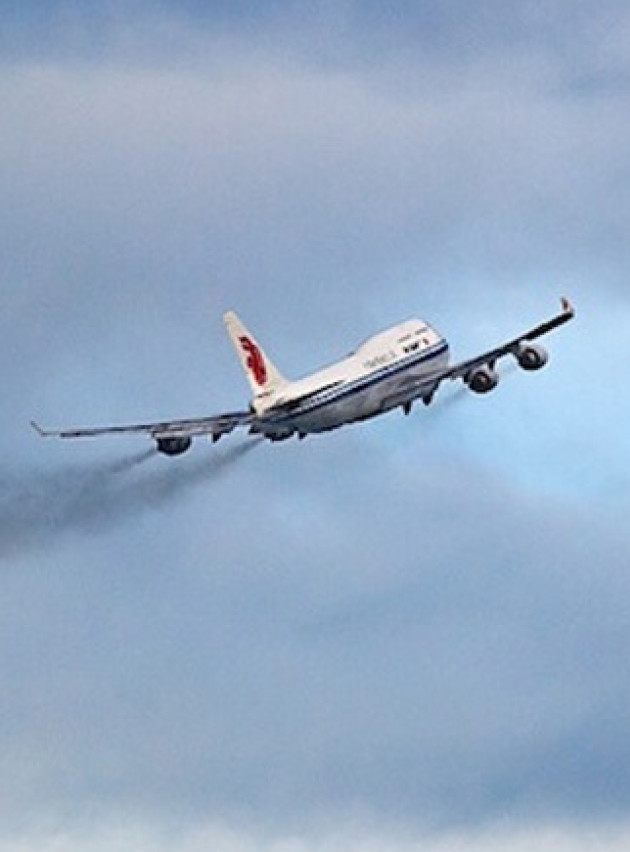 A plane flying into the sky, away from the camera