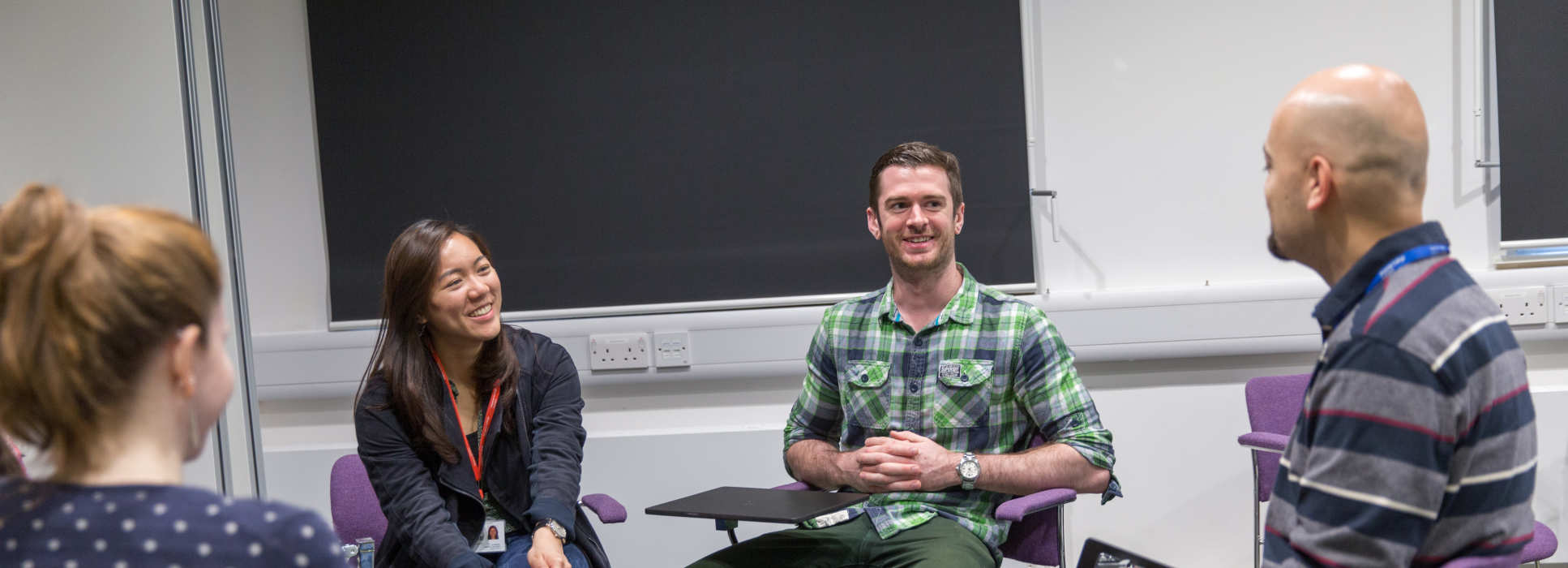 A member of teaching staff chats with students in the School of Public Health