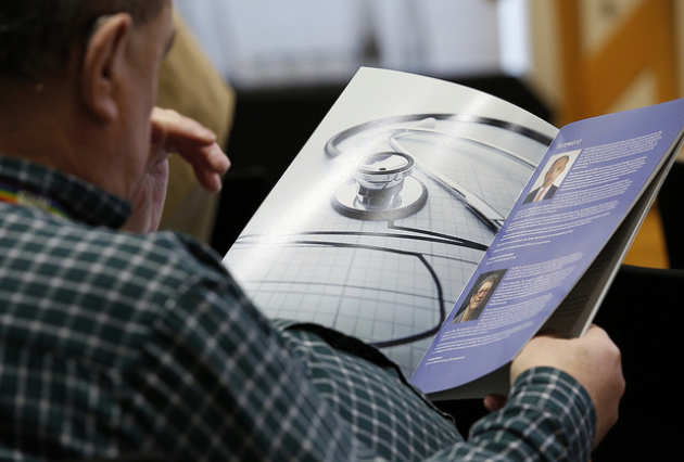 A man reading the symposium agenda