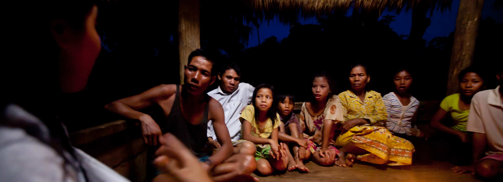 A family listening to a health representative