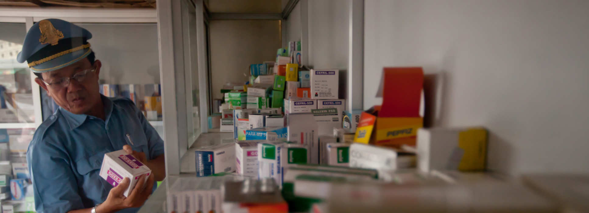 An officer checking for fake anti-malarial drugs