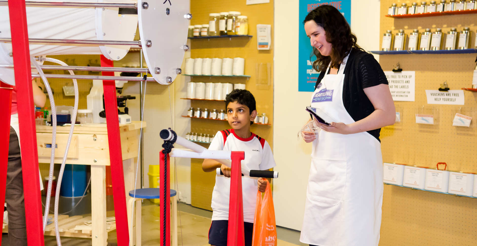 Researcher watches as child tries machine