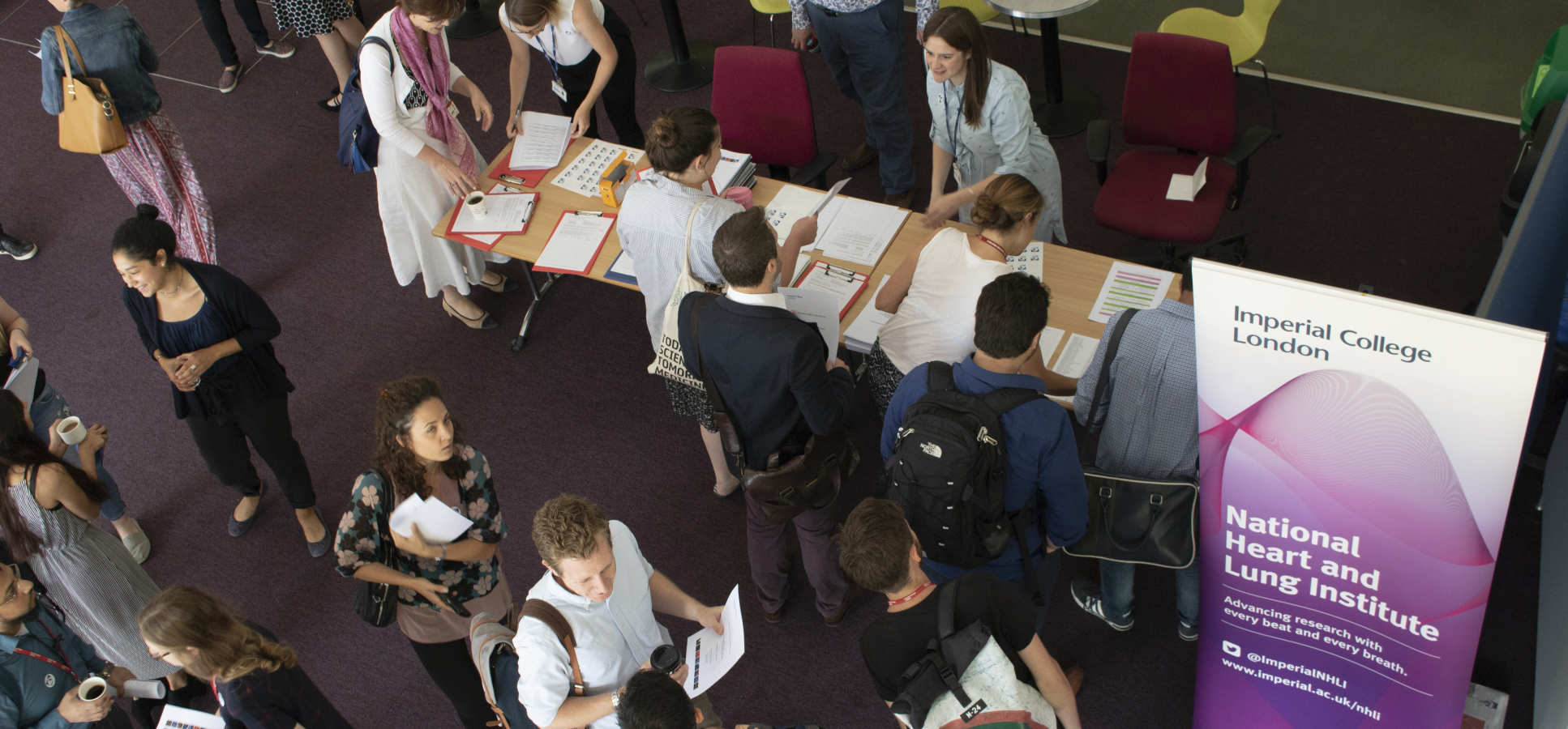 Overhead view of people signing in at event