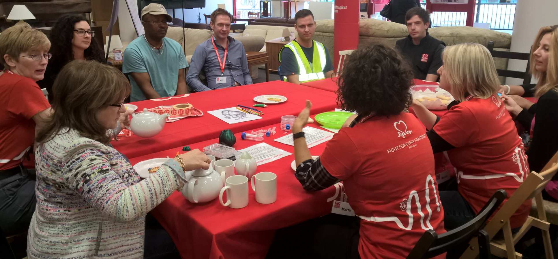 researchers & public sit round table in BHF shop