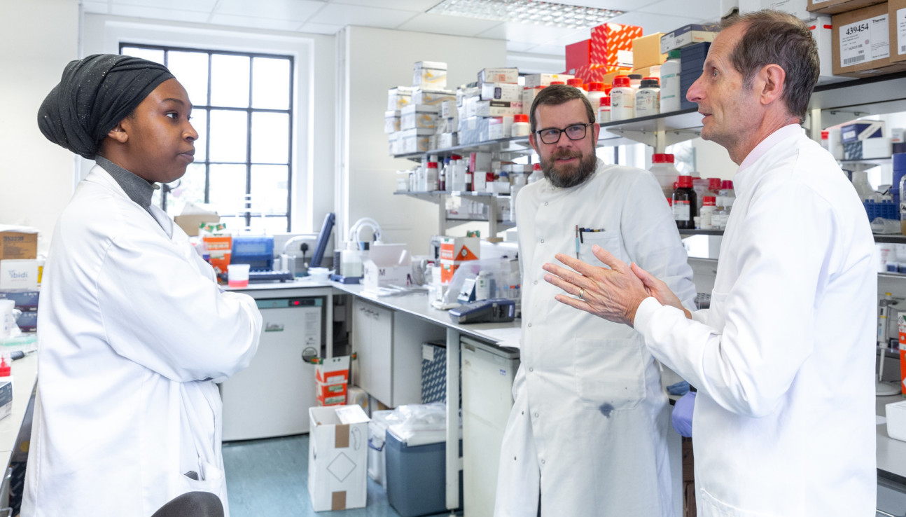 Members of the team talking in the lab