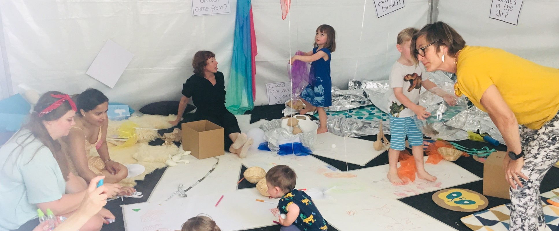 babies on floor with arts materials