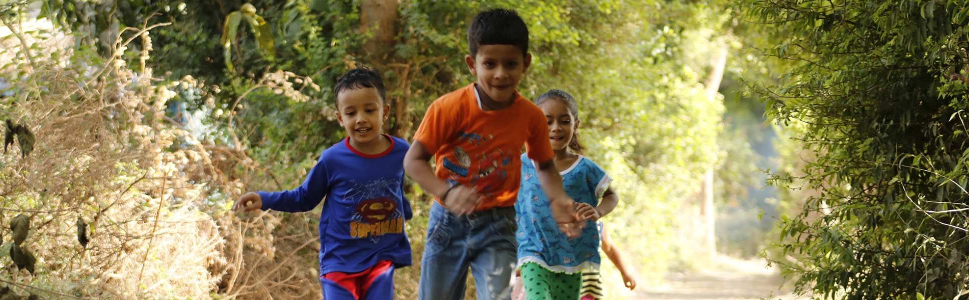 Children running among trees