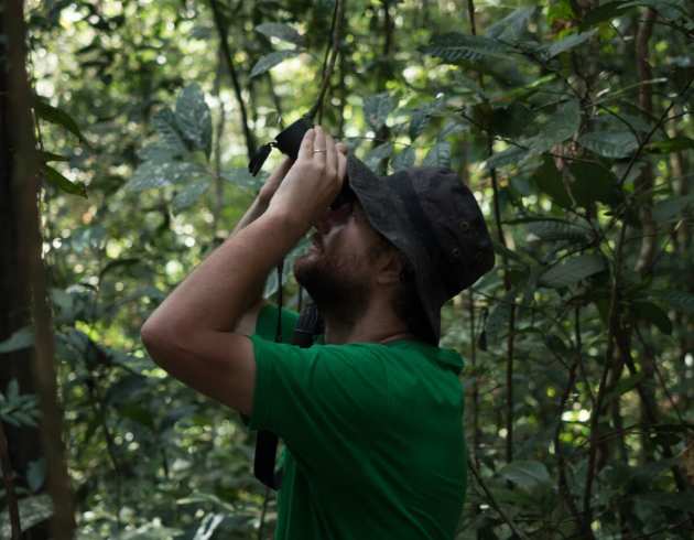 Student looks through binoculars