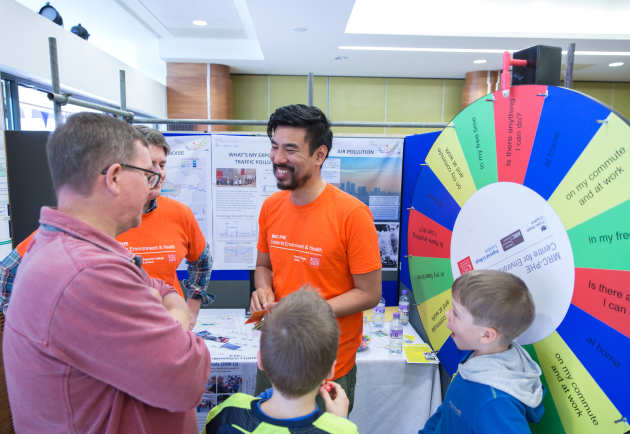 People spin the wheel of fortune at an air pollution activity at the Imperial festival 2017