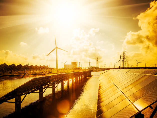 Solar panels and Wind turbine at sunset