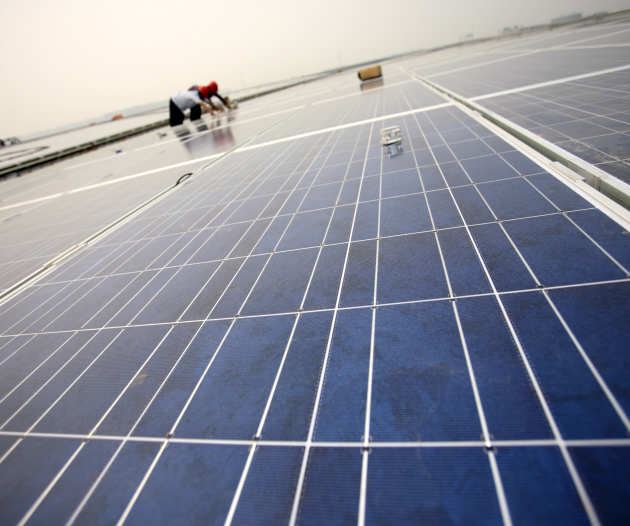 Solar panels with a man in the distance working on them