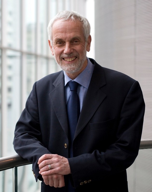 Headshot of Brian Hoskins - white man in a smart suit