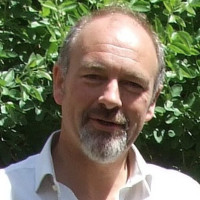 Richard Black outside with a tree behind him on a sunny day 