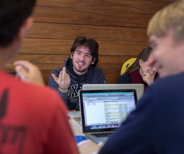 Students chatting together in the library