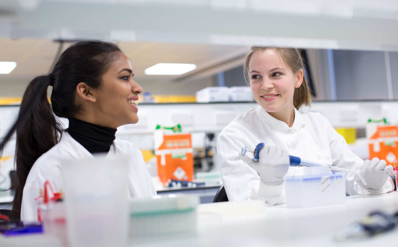 students in discussion in a lab