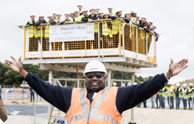 Arms spread with lots of students above on a crane