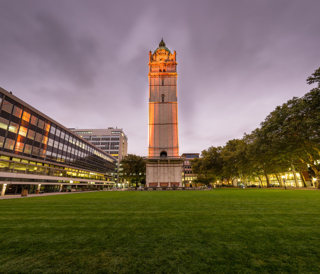 The Imperial Queen's Tower lit up in orange