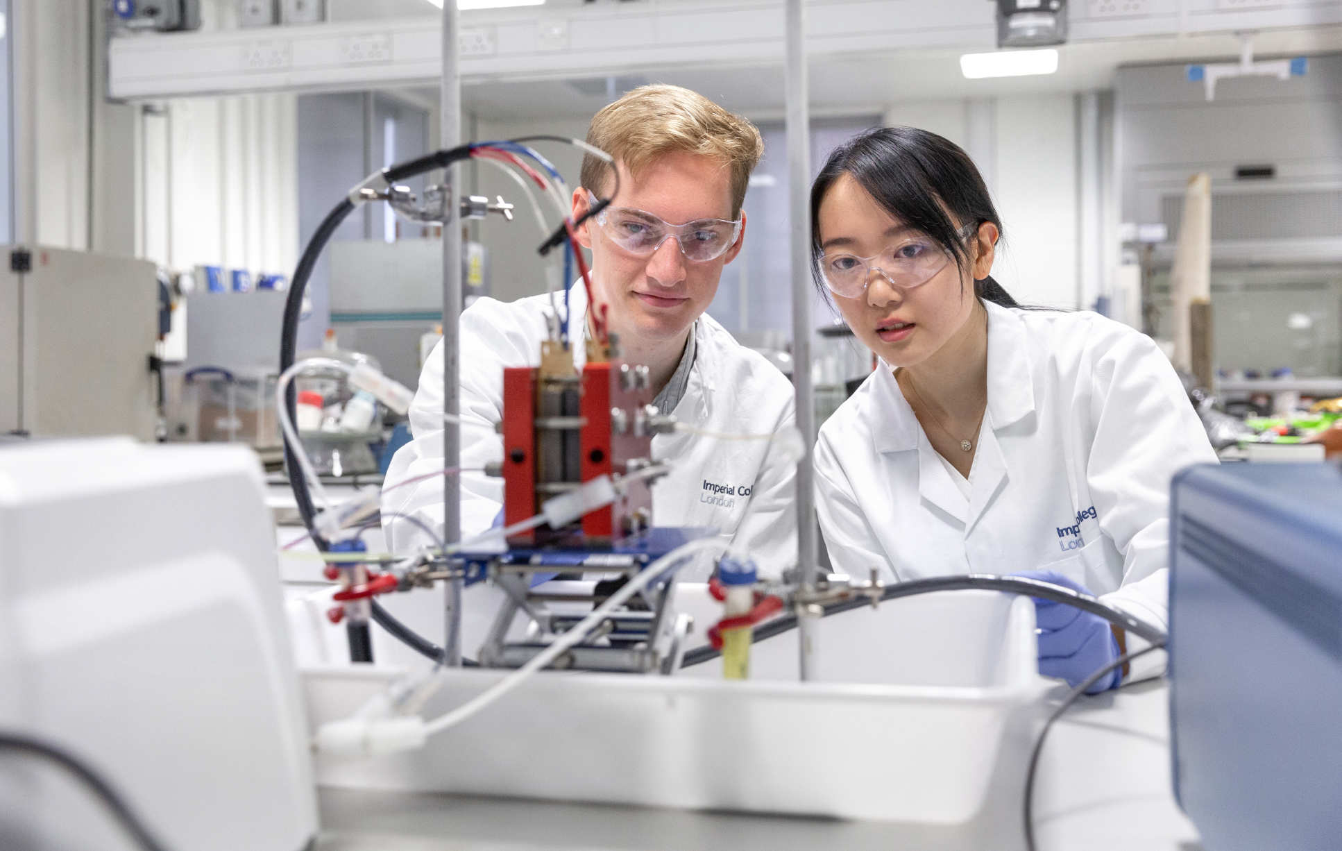 researchers looking at a battery