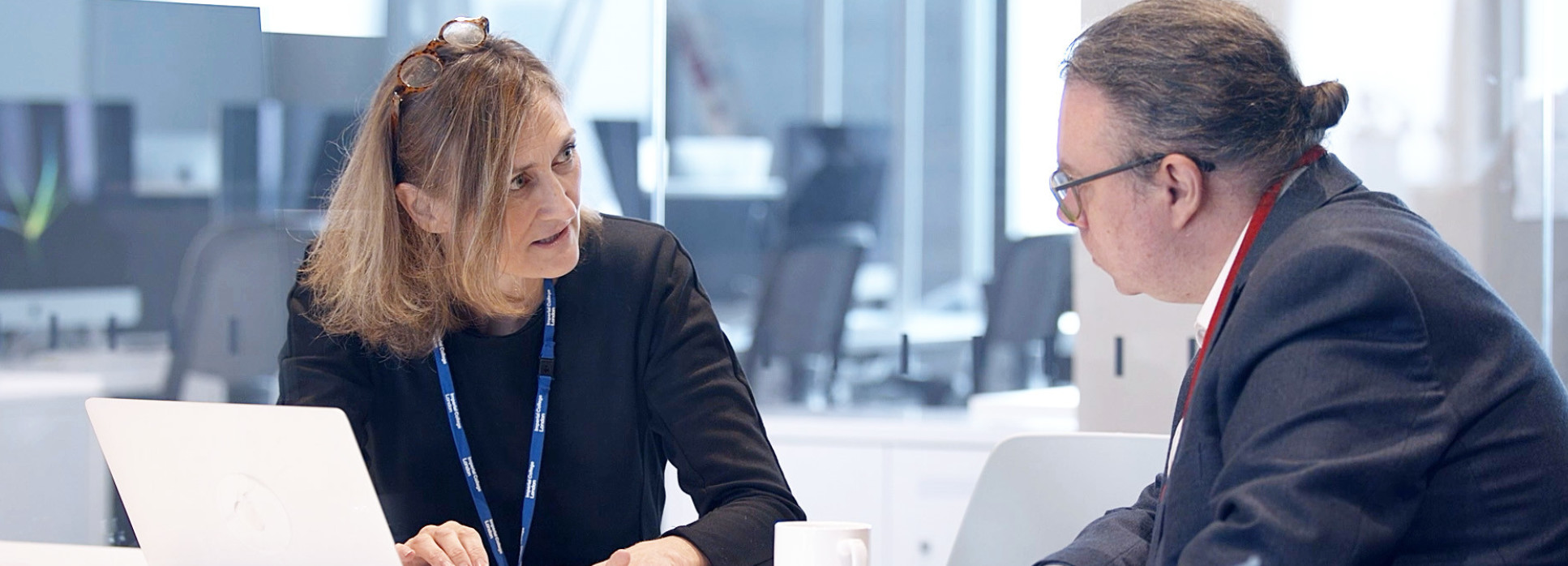 Two people talking over a computer