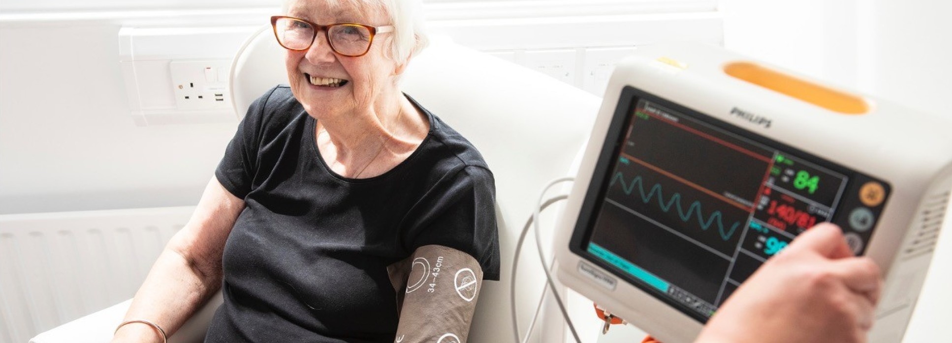 Woman smiling having blood pressure taken