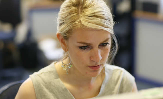 woman looking at computer monitor